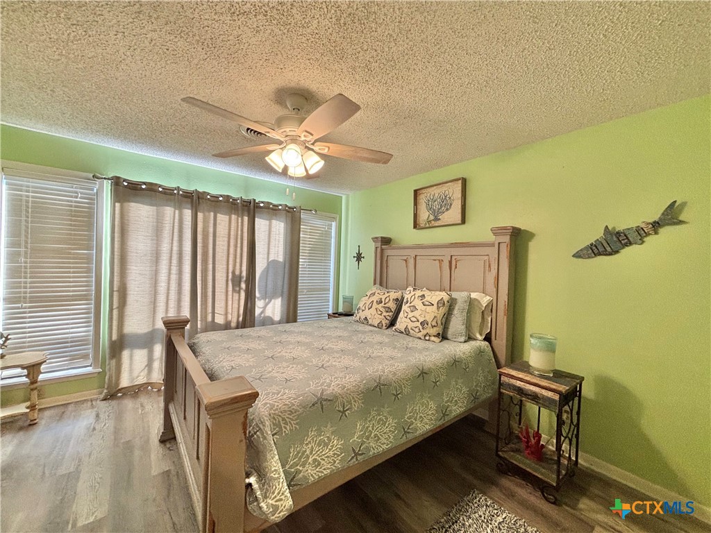 438 15th Street Port O'Connor, TX 77982 - Photo 14 of 26 a bedroom with a bed chandelier and a window