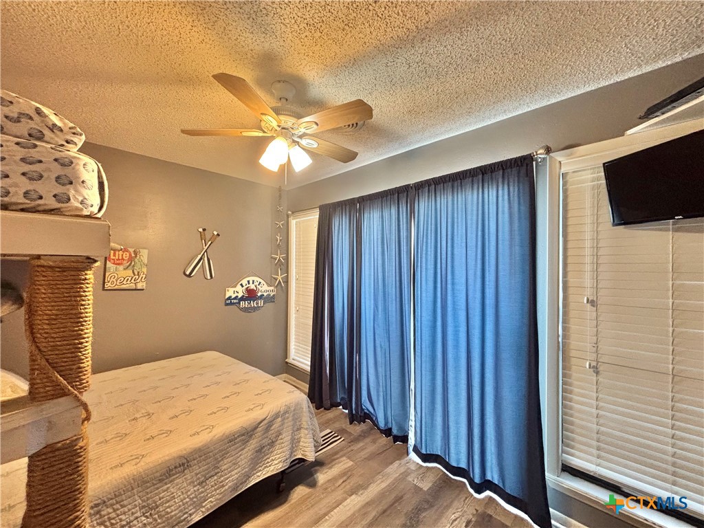 438 15th Street Port O'Connor, TX 77982 - Photo 17 of 26 a bedroom with a bed and a flat screen tv
