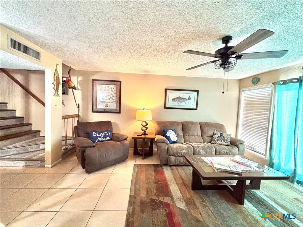 438 15th Street Port O'Connor, TX 77982 - Photo 2 of 26 a living room with furniture and a chandelier