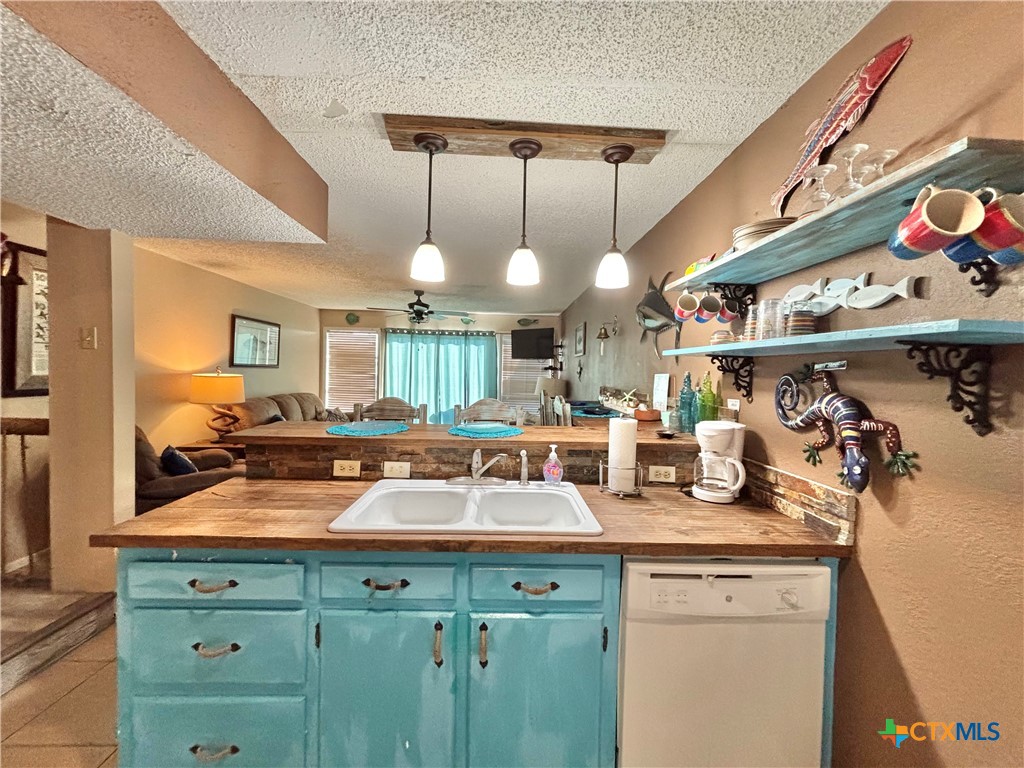 438 15th Street Port O'Connor, TX 77982 - Photo 3 of 26 a kitchen with a sink a stove and cabinets