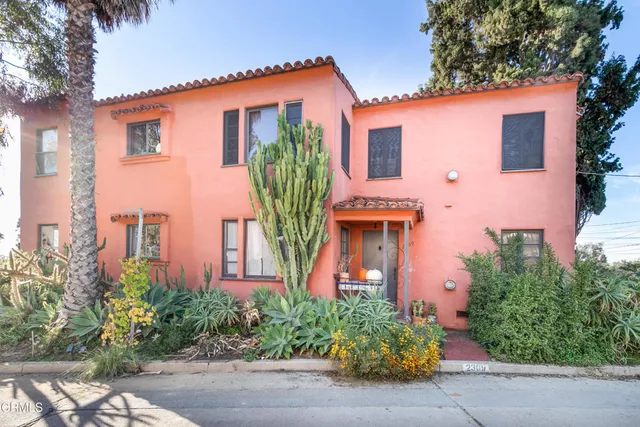front view of a house with potted plants