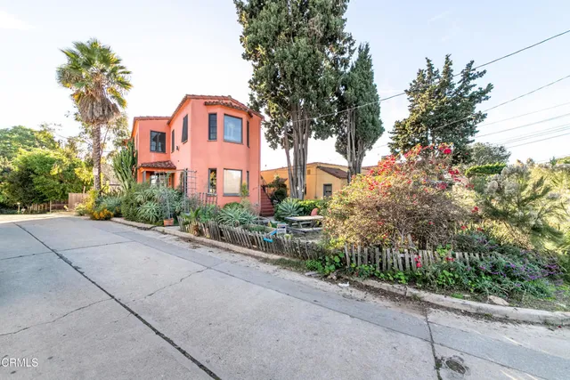 a front view of a house with a yard and a garage