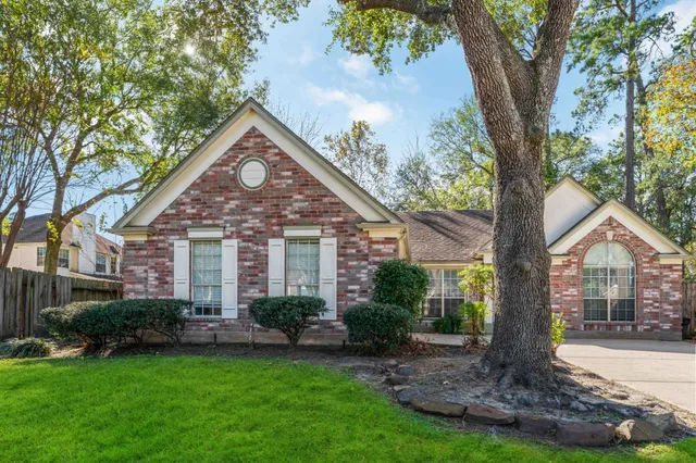 a front view of house with yard and green space