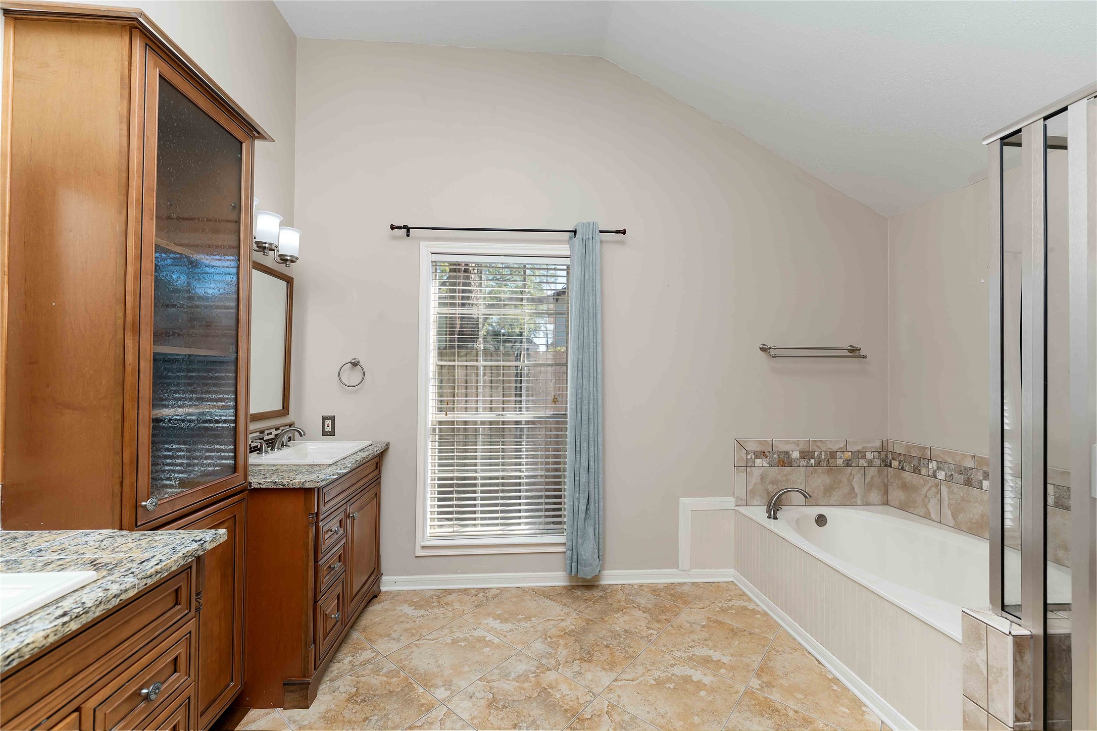 19927 Teller Boulevard Spring, TX 77388 - Photo 22 of 42 a spacious bathroom with a granite countertop tub sink and mirror