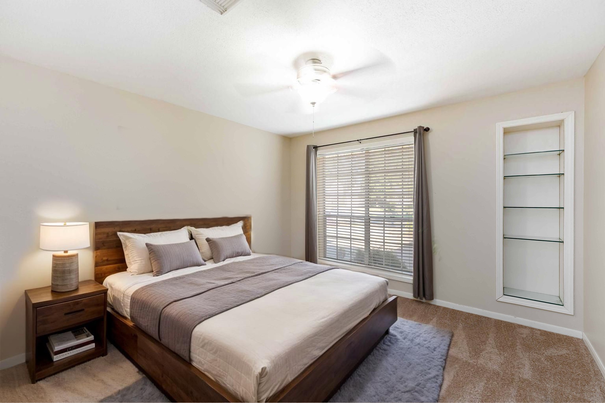19927 Teller Boulevard Spring, TX 77388 - Photo 26 of 42 a bedroom with a large bed and a chandelier