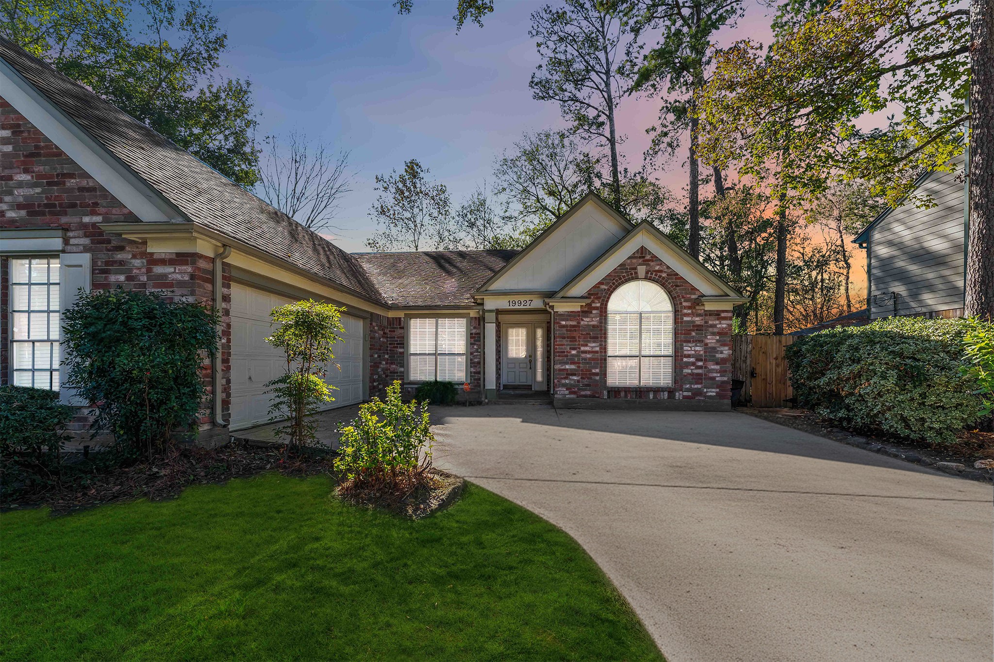19927 Teller Boulevard Spring, TX 77388 - Photo 3 of 42 Front elevation at dusk showcasing integrated exterior lighting and a mix of brick and siding.