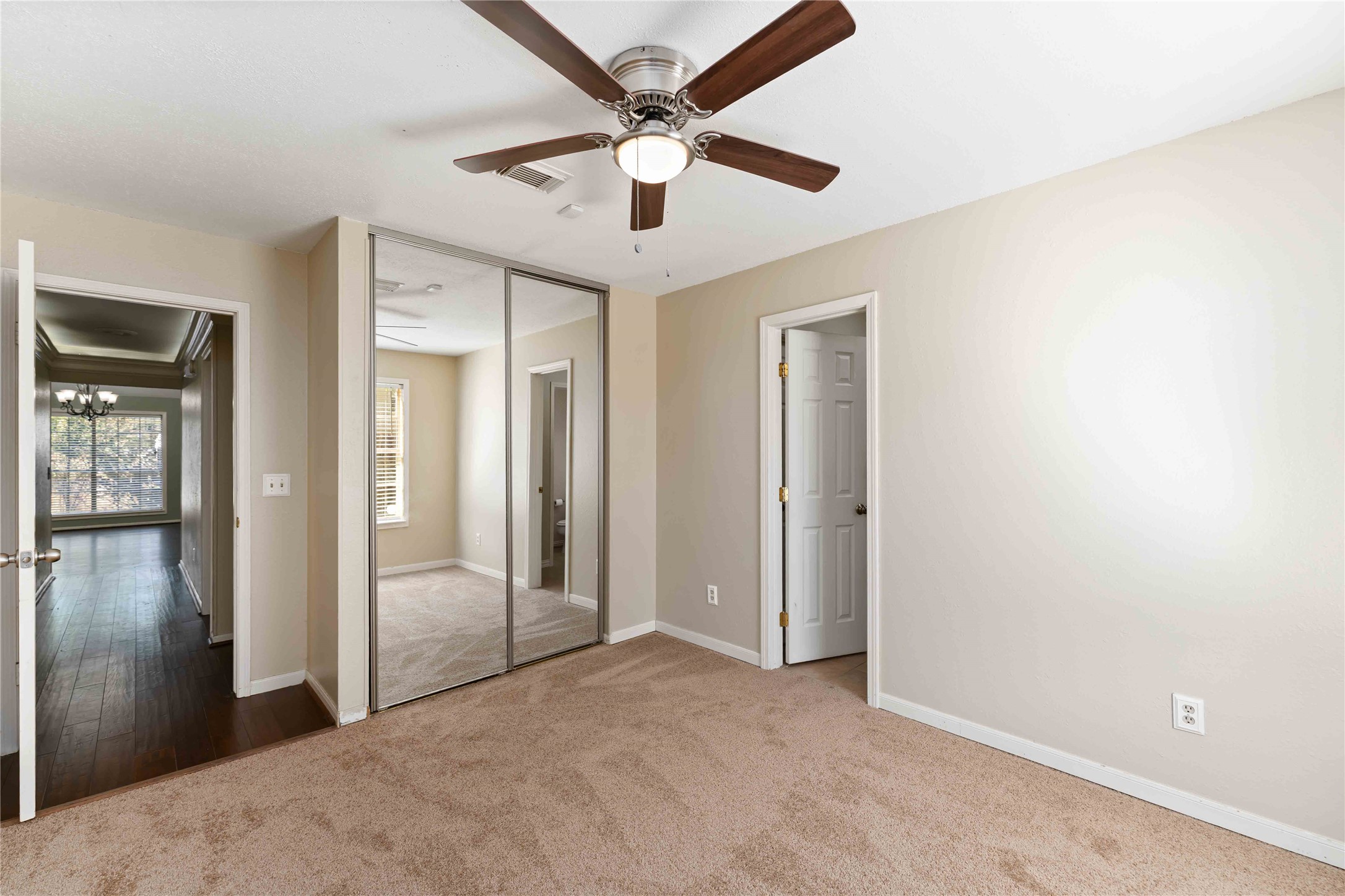 19927 Teller Boulevard Spring, TX 77388 - Photo 29 of 42 an empty room with closet and a chandelier fan