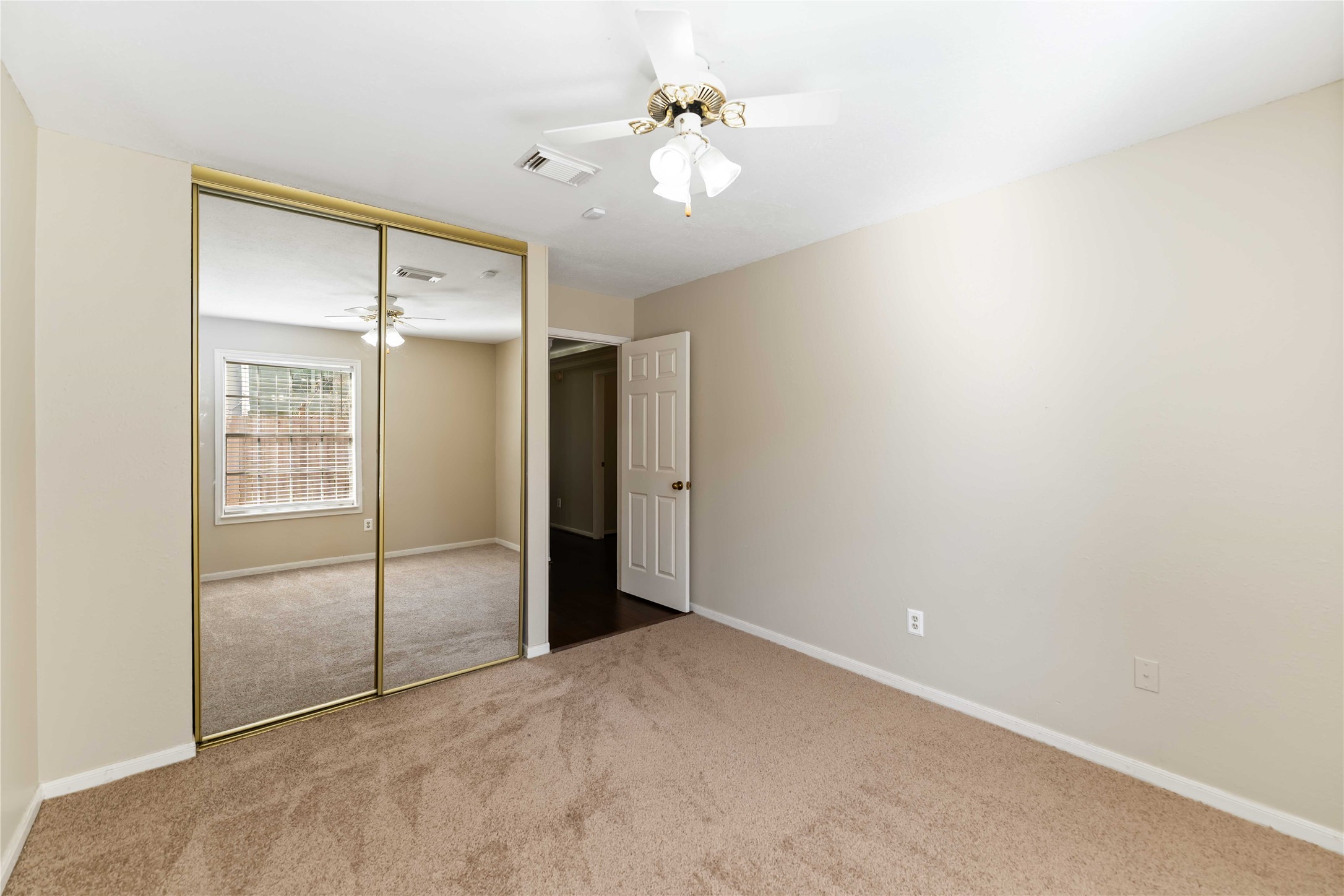 19927 Teller Boulevard Spring, TX 77388 - Photo 32 of 42 Another View of Bedroom 4 featuring a large floor-to-ceiling mirrored closet doors that reflect the natural light from the window.