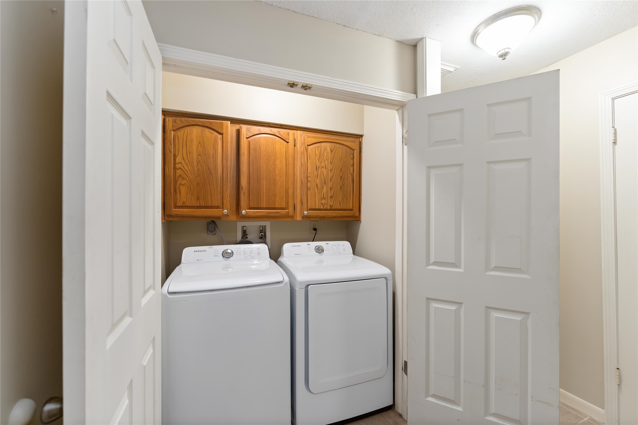 19927 Teller Boulevard Spring, TX 77388 - Photo 35 of 42 The dedicated laundry area with upper wood cabinetry conveniently located from the four bedrooms.