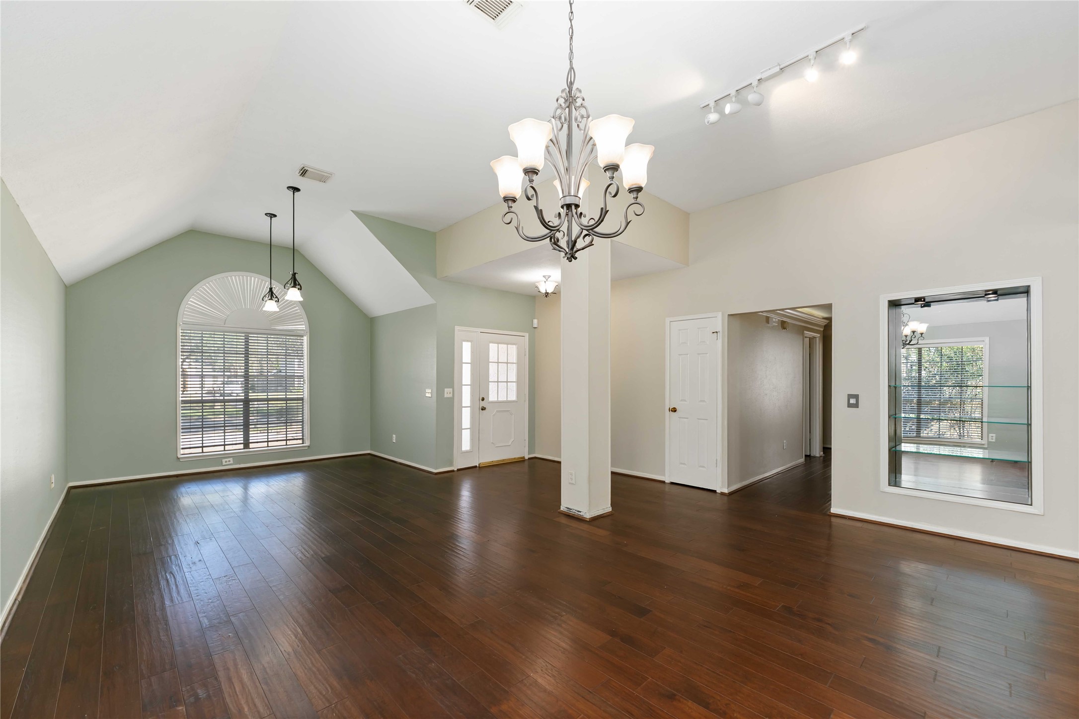 19927 Teller Boulevard Spring, TX 77388 - Photo 6 of 42 Open-concept layout highlighting a glass-shelved wall niche and overhead track lighting.