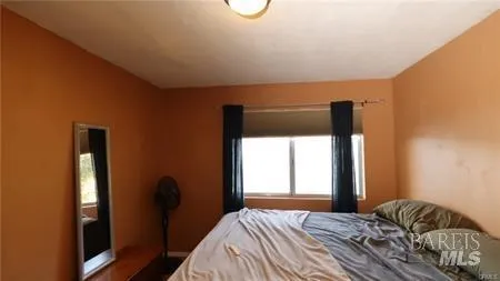 a bathroom with a granite countertop sink a mirror and a shower