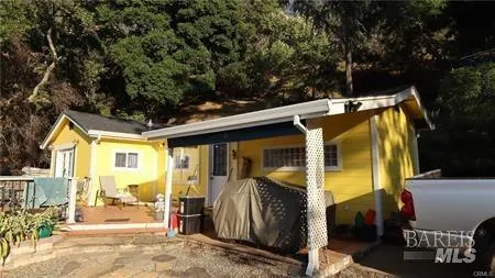 a bathroom with a granite countertop toilet and a sink