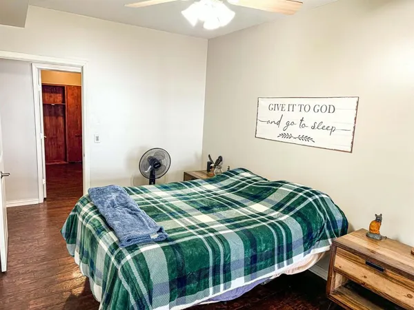 a bedroom with a bed and wooden floor