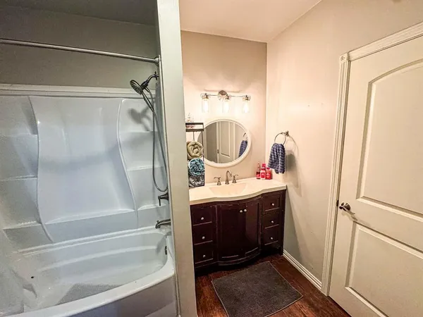 a bathroom with a shower and a tub