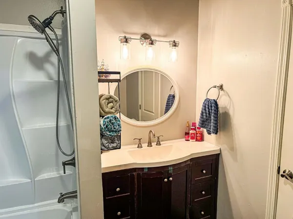 a bathroom with a shower curtain and a sink