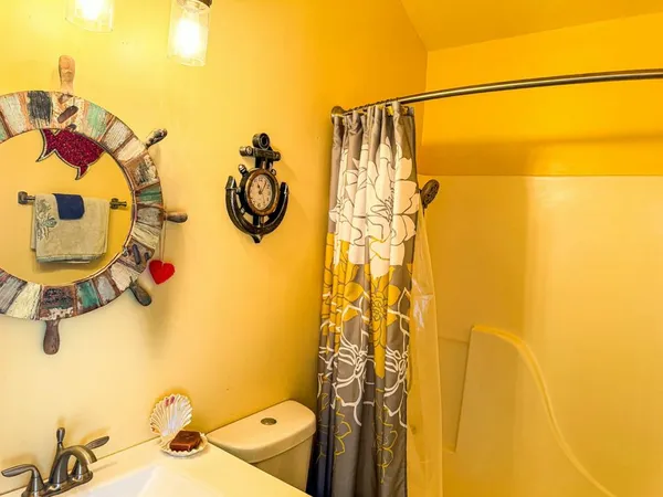 a bathroom with a shower curtain and a shower curtain