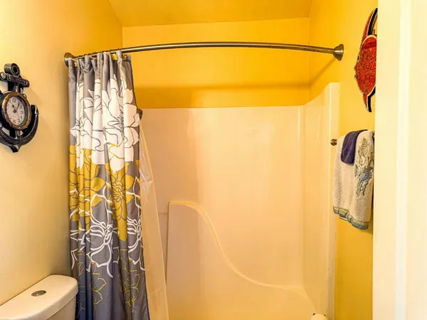 a view of a backyard with wooden fence