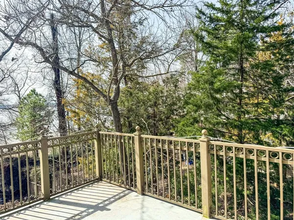 a view of a wooden deck with chairs and a yard
