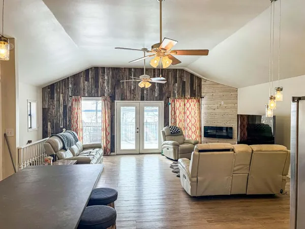 a living room with fireplace furniture and a large window