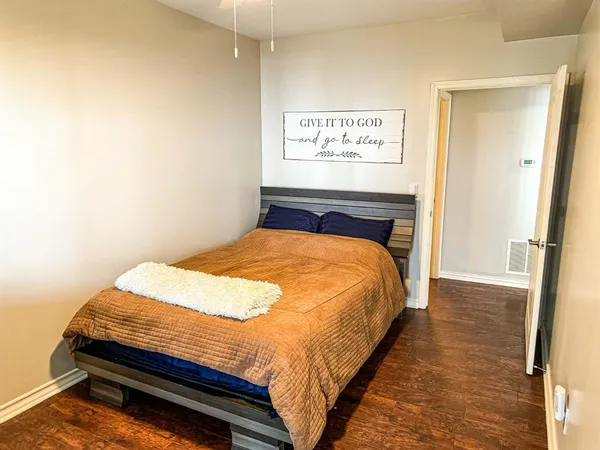 a bed sitting in a bedroom next to a bathroom