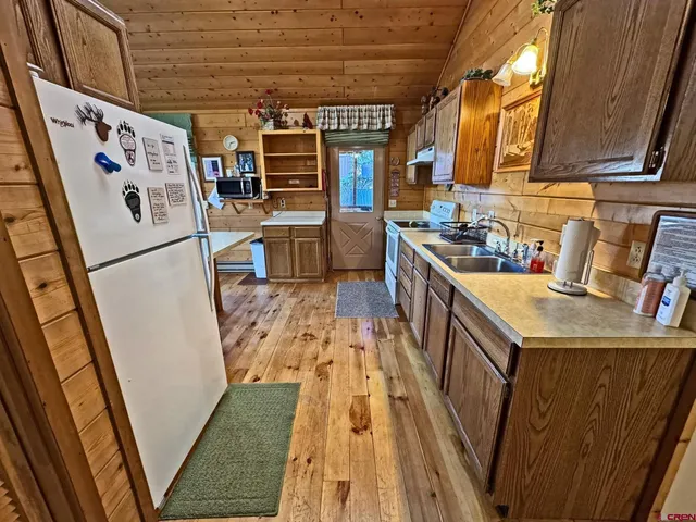 a kitchen with a stove a refrigerator and a sink