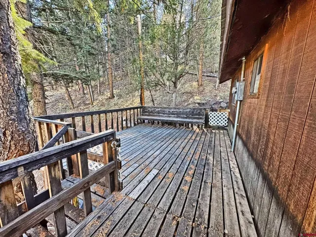 a view of backyard with deck and wooden floor
