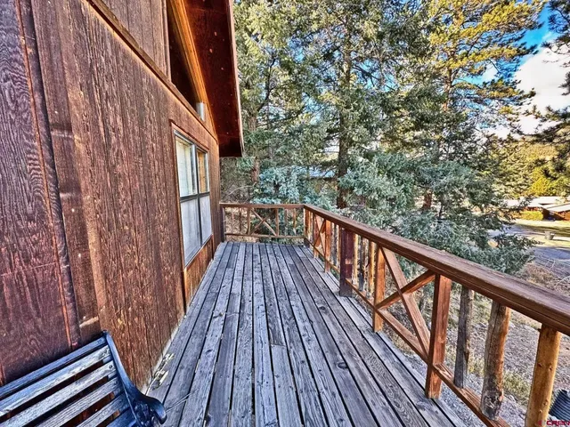 a balcony with wooden floor and fence