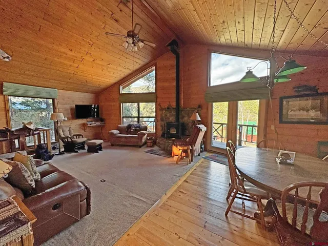 a living room with furniture a wooden floor and a large window