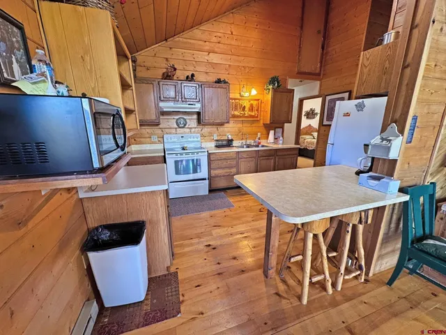 a view of a kitchen with furniture and a kitchen