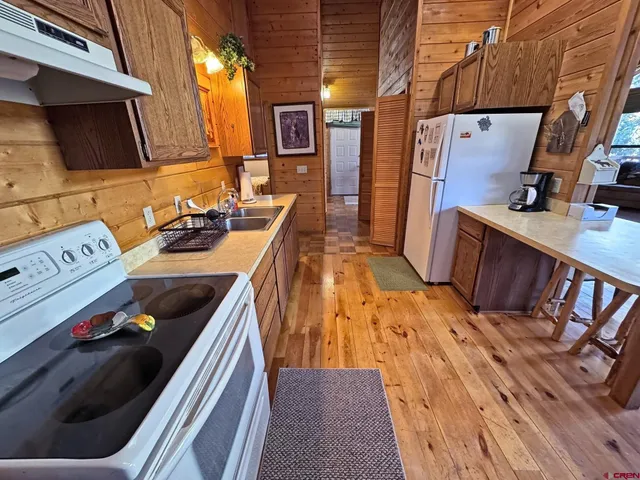 a view of a kitchen with wooden floor