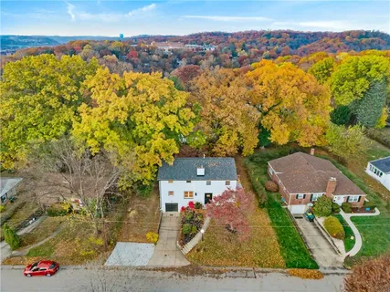 an aerial view of a house with a swimming pool