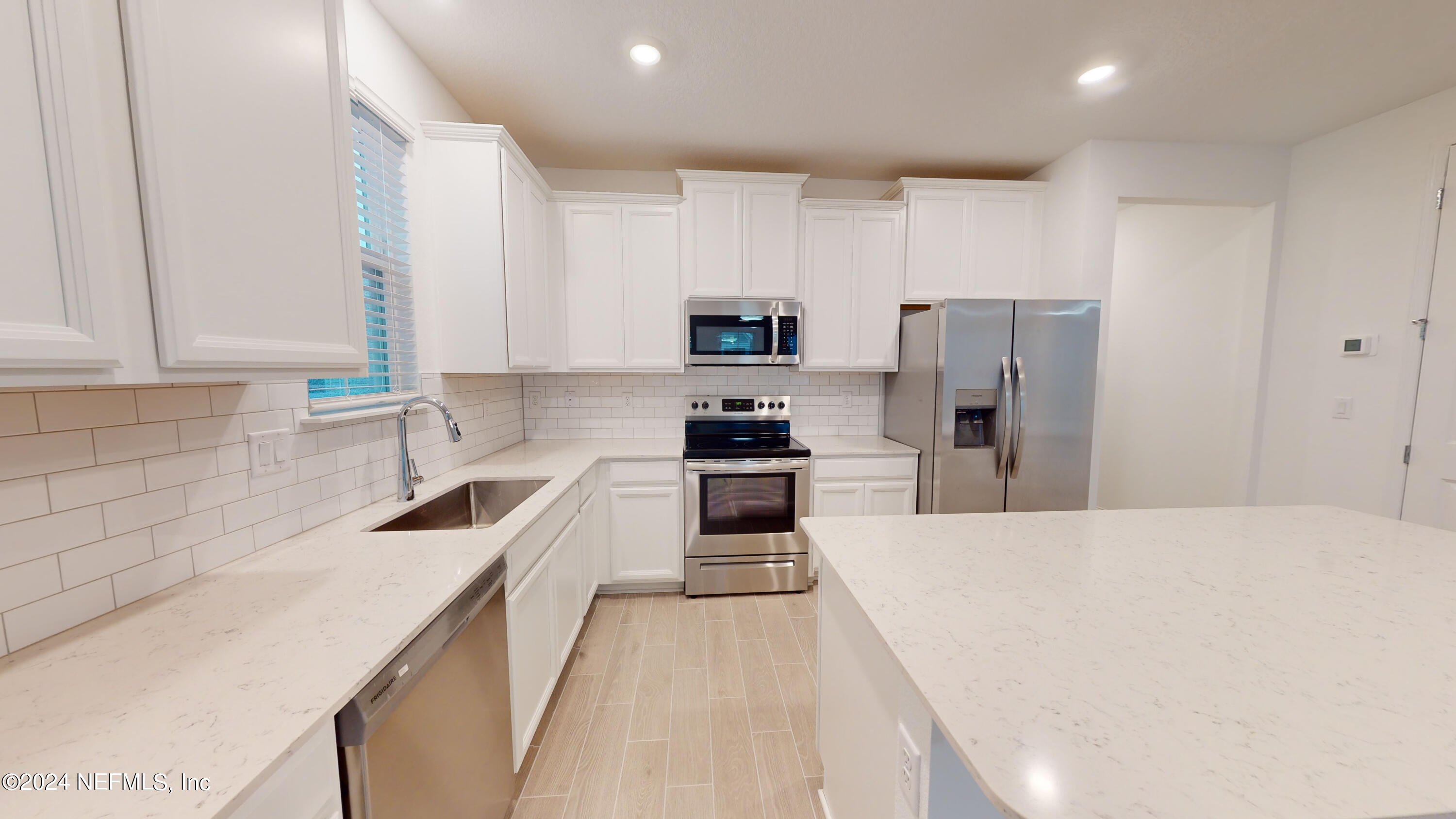 52 Tyson Ct Street St. Augustine, FL 32092 - Photo 13 of 31 a kitchen with refrigerator a stove and cabinets