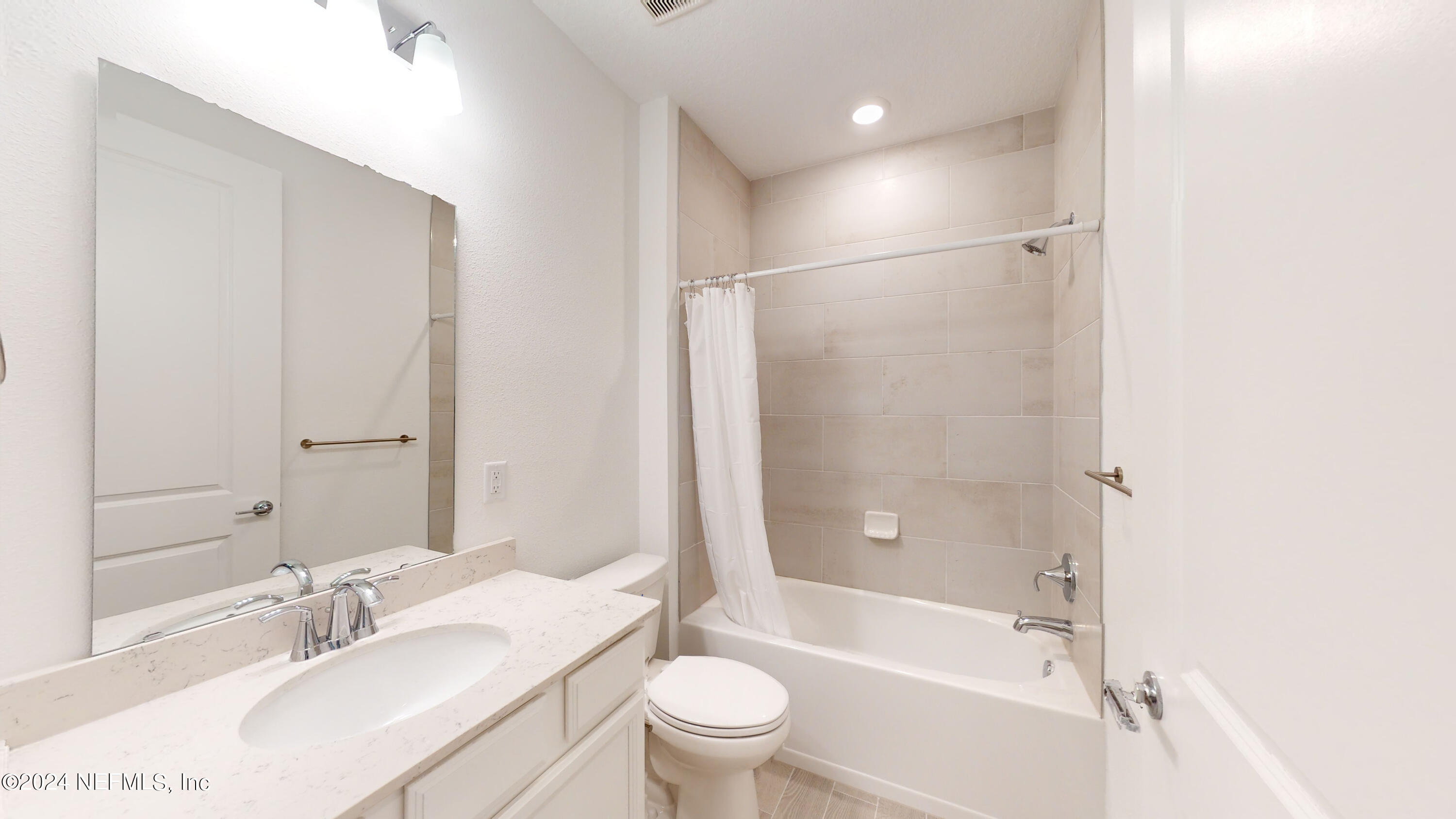 52 Tyson Ct Street St. Augustine, FL 32092 - Photo 14 of 31 a bathroom with a bathtub shower sink vanity and toilet