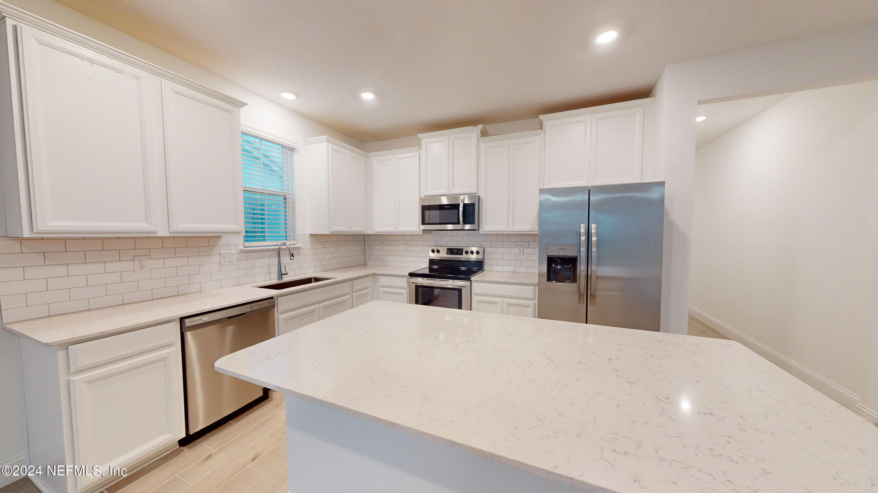 52 Tyson Ct Street St. Augustine, FL 32092 - Photo 18 of 31 a kitchen with white cabinets and stainless steel appliances
