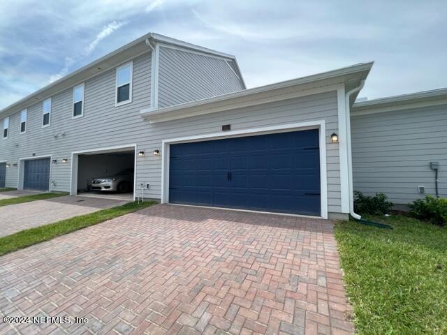 52 Tyson Ct Street St. Augustine, FL 32092 - Photo 20 of 31 a front view of a house with a yard and garage