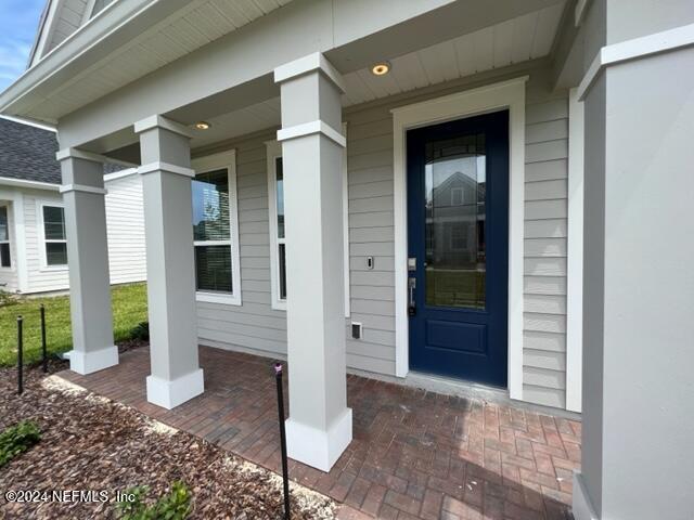 52 Tyson Ct Street St. Augustine, FL 32092 - Photo 4 of 31 a front view of a house with a porch