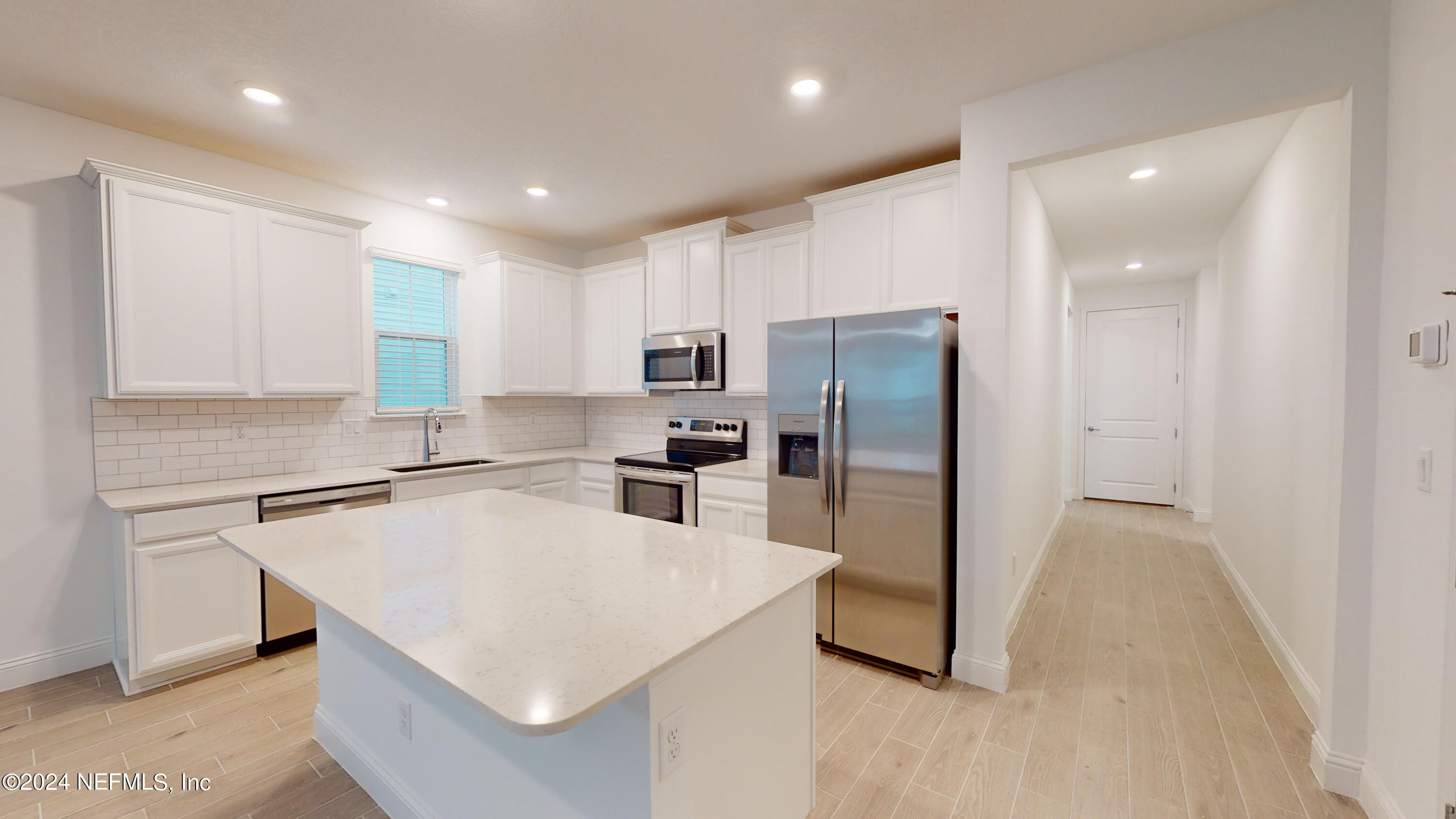 52 Tyson Ct Street St. Augustine, FL 32092 - Photo 7 of 31 a kitchen with stainless steel appliances a refrigerator sink and microwave