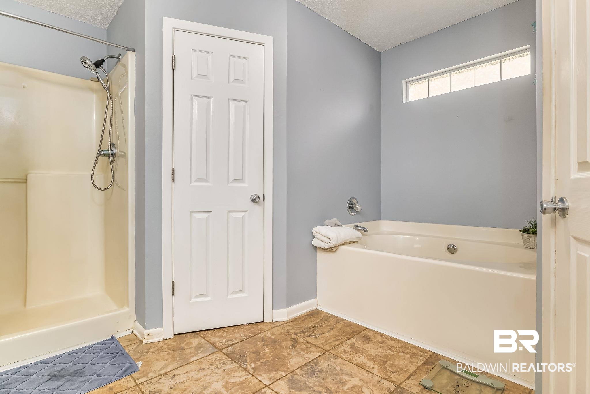 12199 Bay Road West Foley, AL 36535 - Photo 33 of 62 Full bathroom with a garden tub, a shower stall, and a textured ceiling
