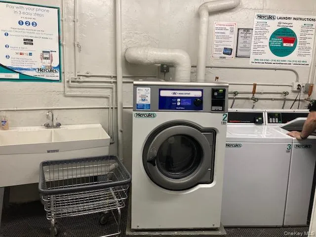 a bathroom with a sink and a painting on the wall