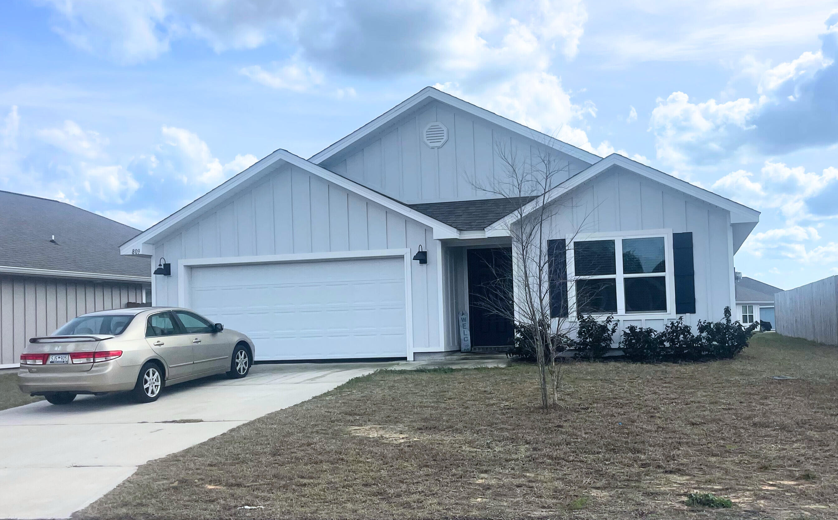 809 Otto Loop Crestview, FL 32539 - Photo 1 of 26 a front view of a house with garden