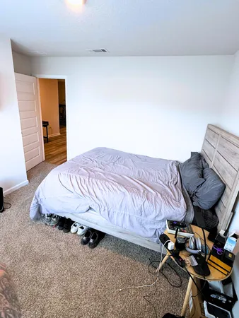 a bedroom with a bed and a window