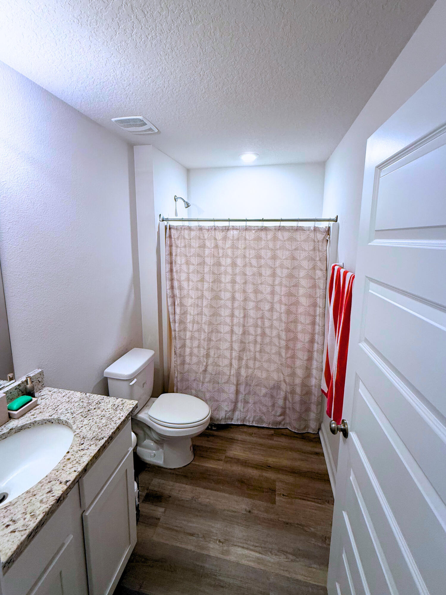 809 Otto Loop Crestview, FL 32539 - Photo 19 of 26 a bathroom with a granite countertop toilet sink and shower