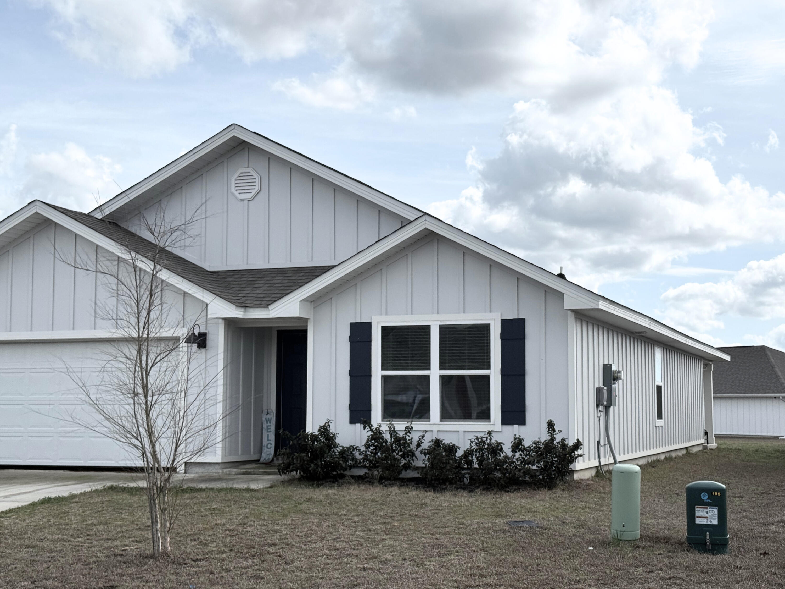 809 Otto Loop Crestview, FL 32539 - Photo 2 of 26 a front view of a house with a garden