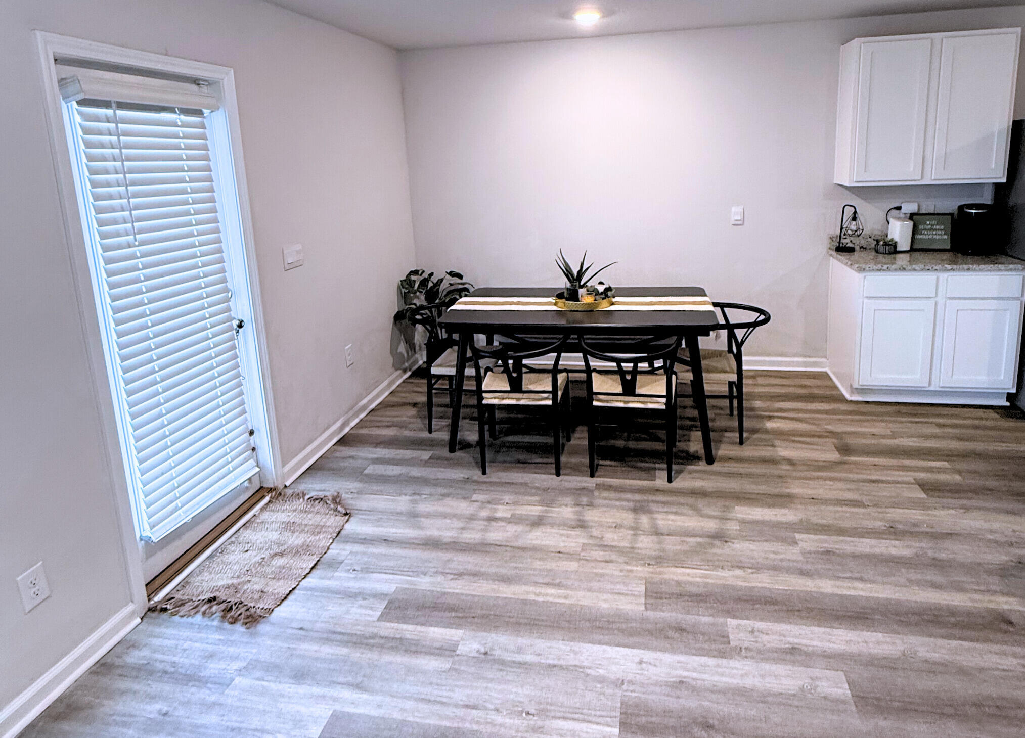 809 Otto Loop Crestview, FL 32539 - Photo 7 of 26 a view of a dining room with furniture and wooden floor