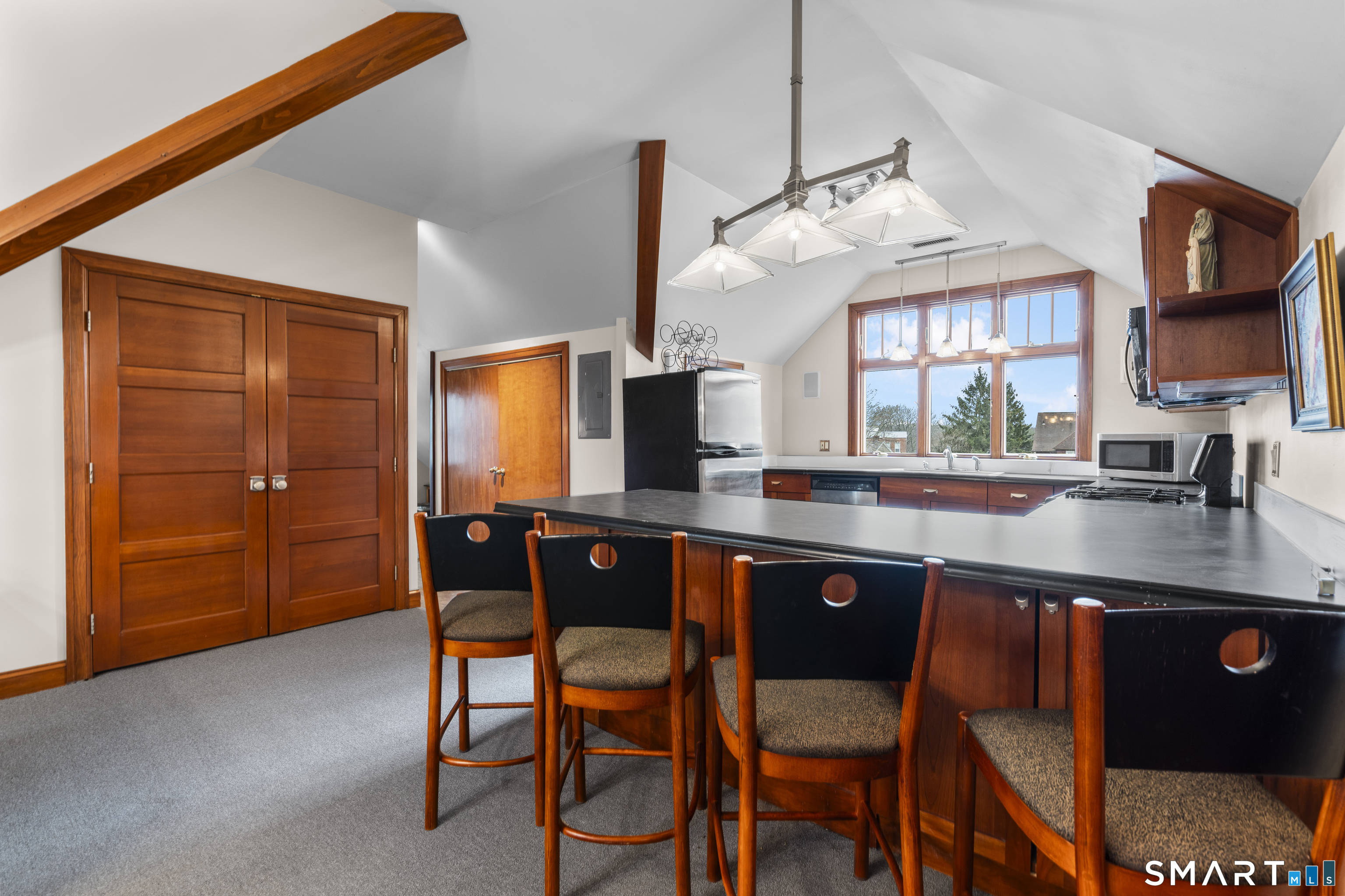 105 Howe Avenue Shelton, CT 06484 - Photo 22 of 38 a kitchen with a sink cabinets and dining table chair