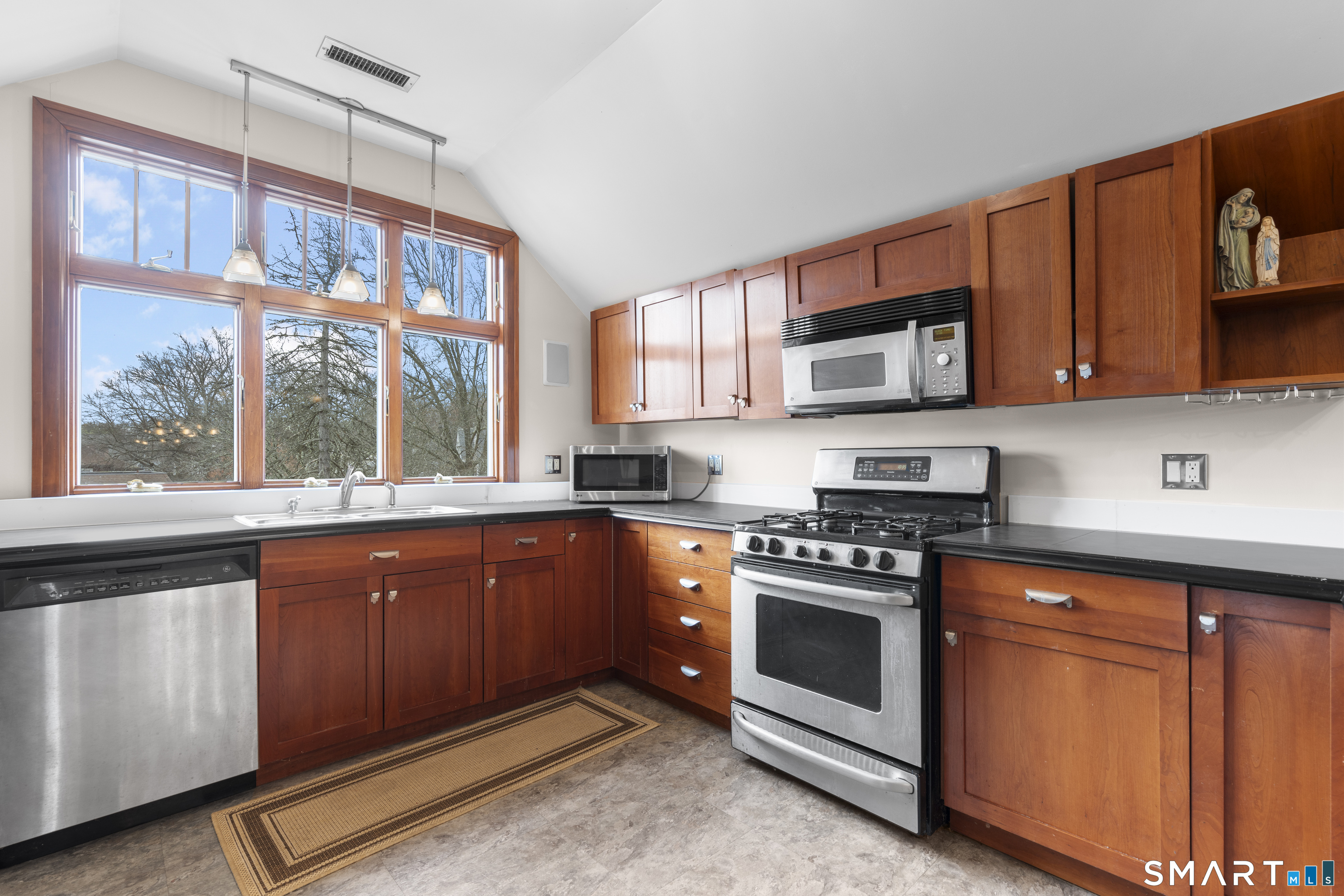 105 Howe Avenue Shelton, CT 06484 - Photo 26 of 38 a kitchen with stainless steel appliances granite countertop a stove a sink and a microwave