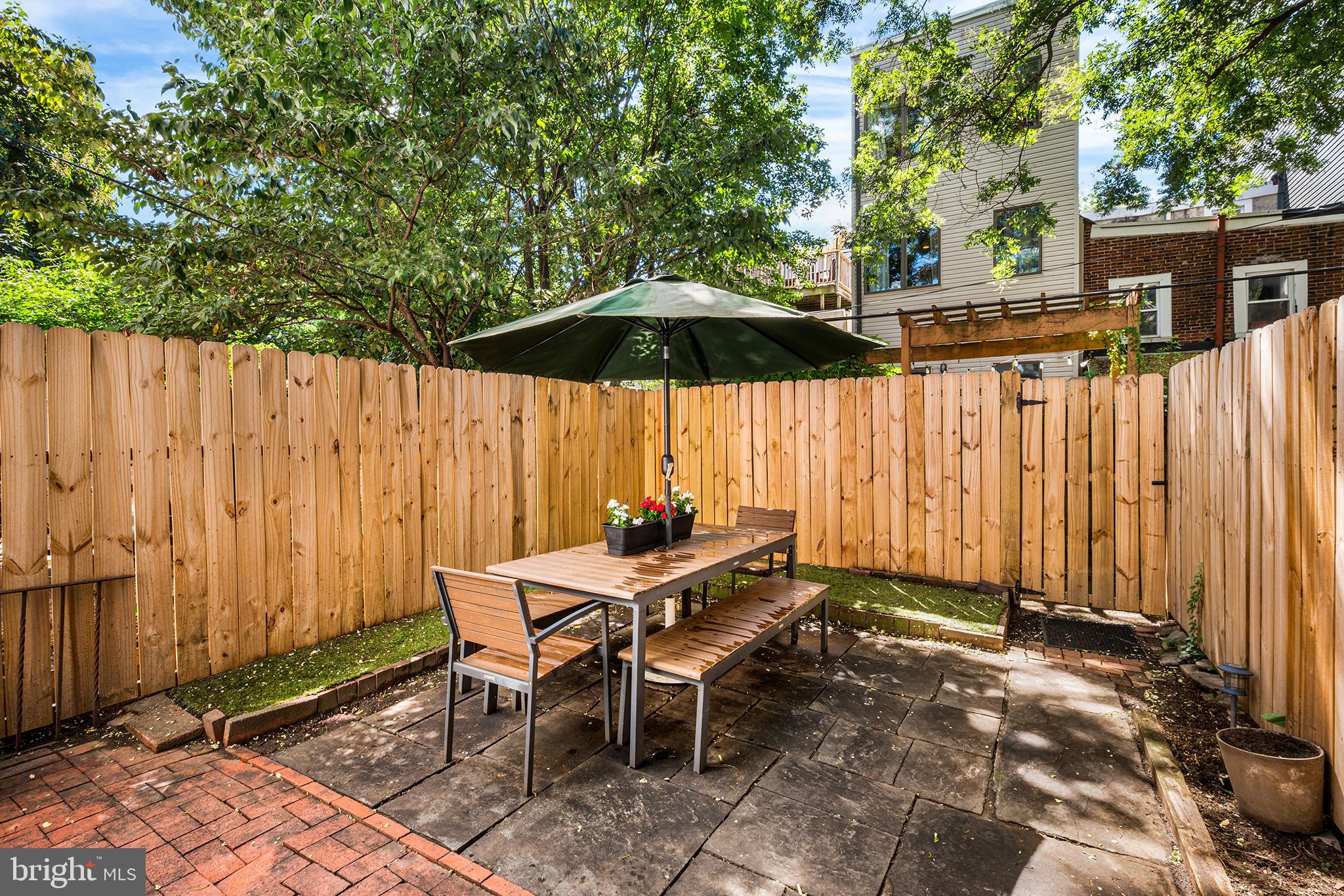 2014 Pemberton Street Philadelphia, PA 19146 - Photo 11 of 24 a view of backyard with table and chairs under an umbrella
