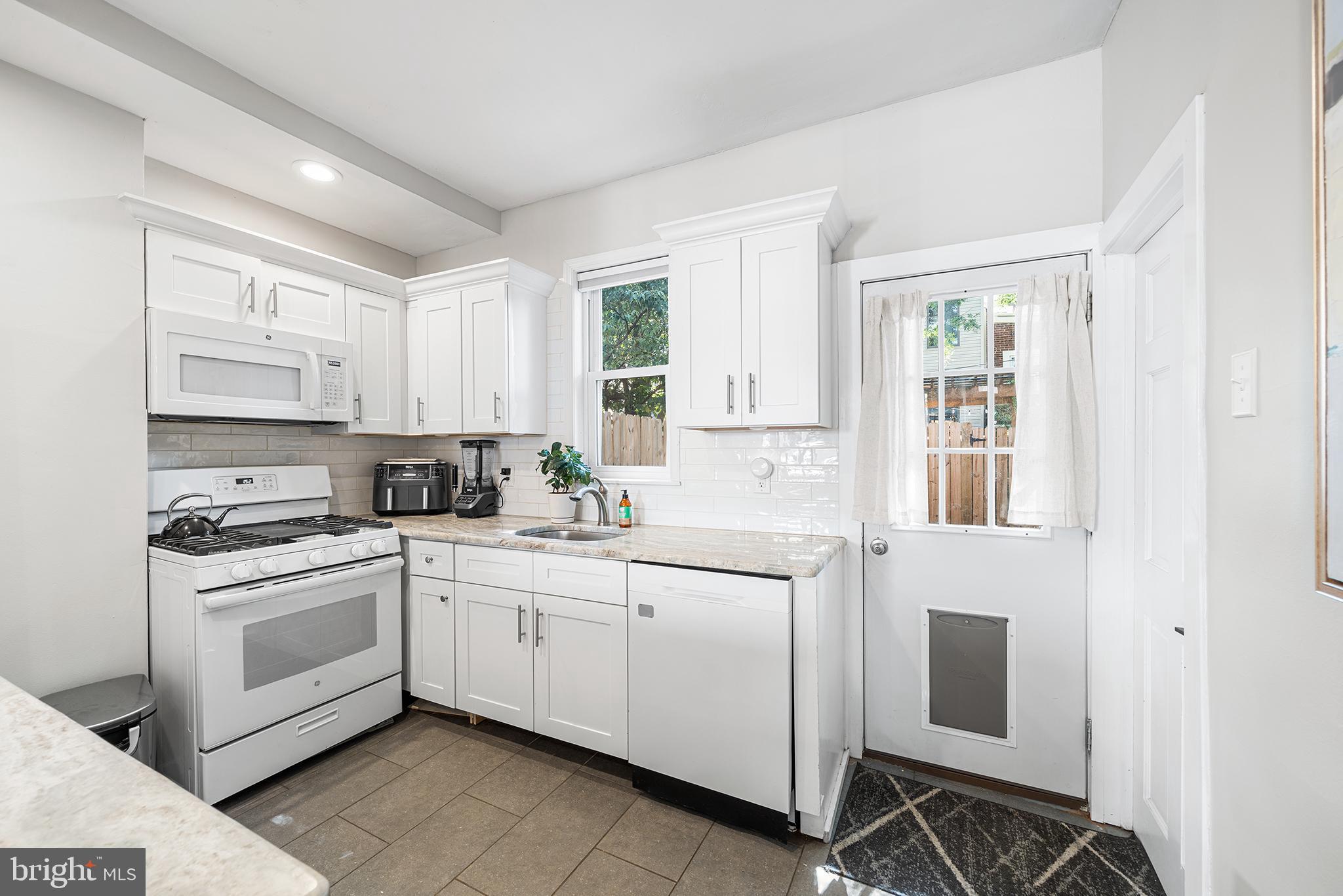 2014 Pemberton Street Philadelphia, PA 19146 - Photo 12 of 24 a kitchen with white cabinets and white appliances