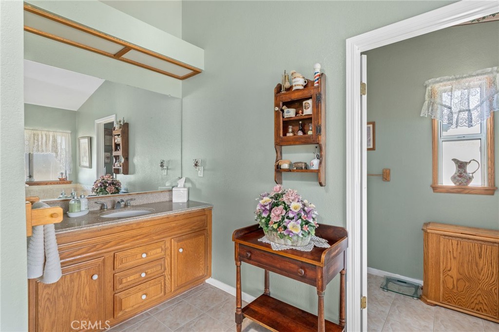 1087 Lockwood Valley Road Maricopa, CA 93252 - Photo 25 of 74 a room with a wooden cabinets and clock on the wall