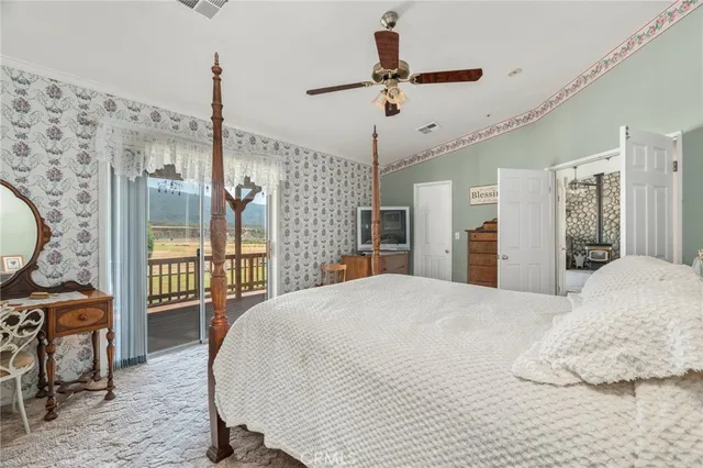 a view of a patio with a table and chairs under an umbrella
